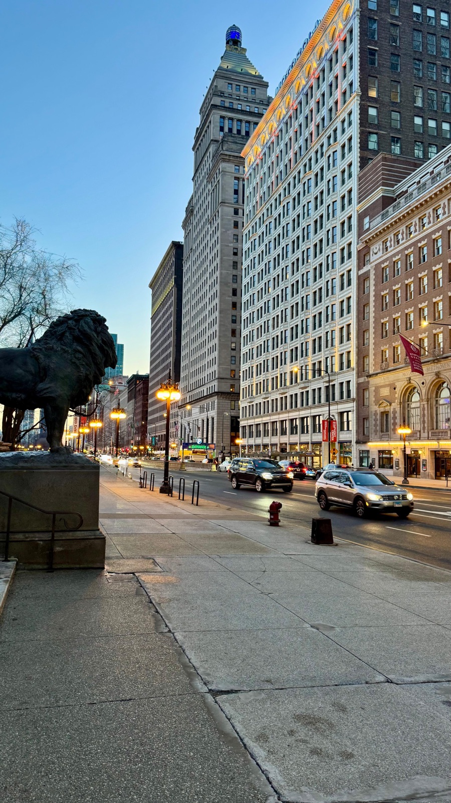 Art Institute lion statue on Michigan Avenue at dusk