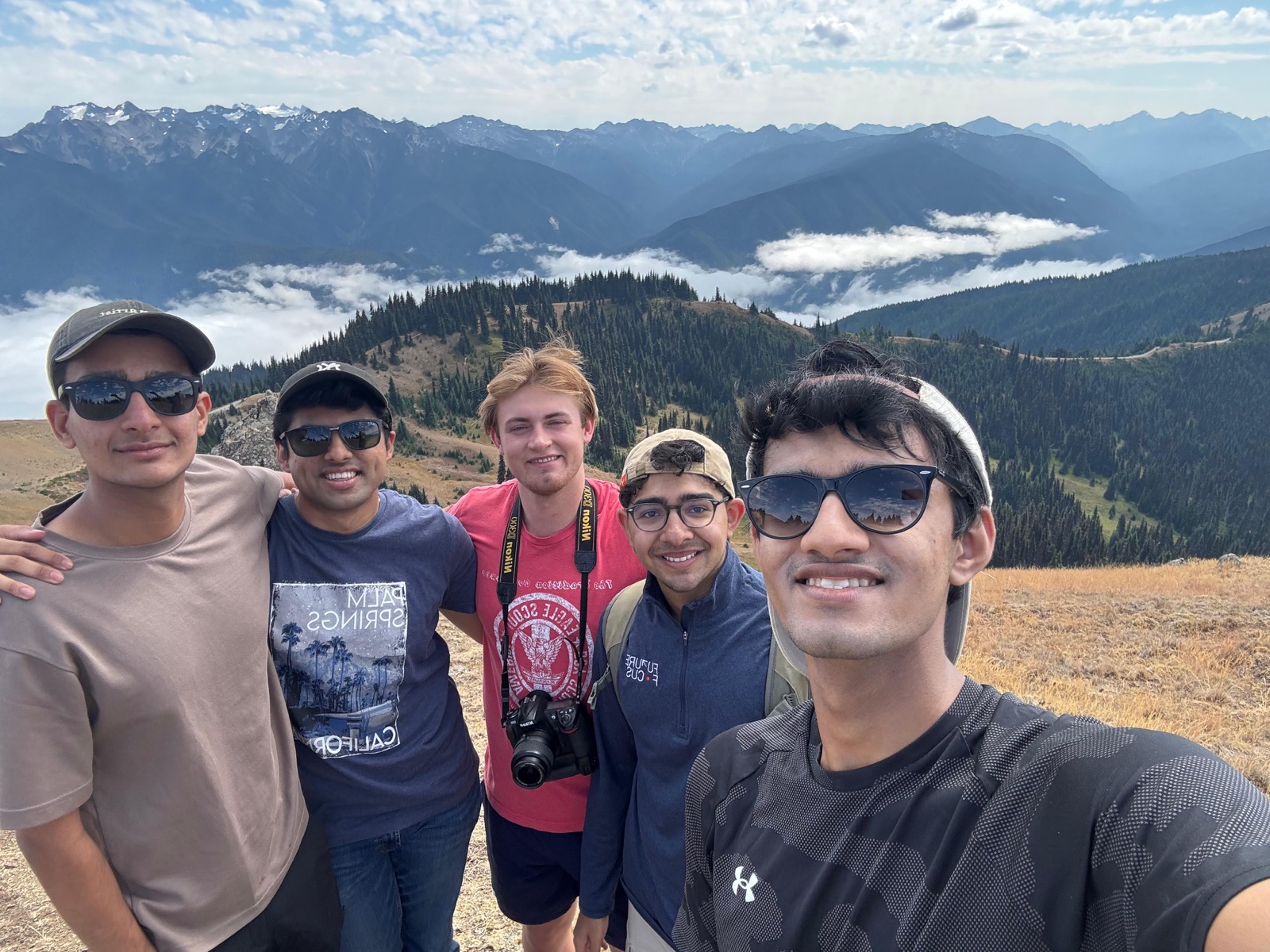 Five friends on a hike at Hurricane Ridge with mountains behind